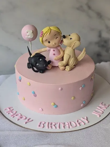 A girl and her best friends. This sweet pink cake is for a little girl who loves her two dogs, featuring cute figurines of the trio.