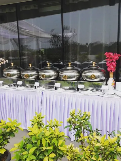 The full buffet line for the Sudha Carpets lunch. The setup is clean, professional, and inviting for the 50 guests.