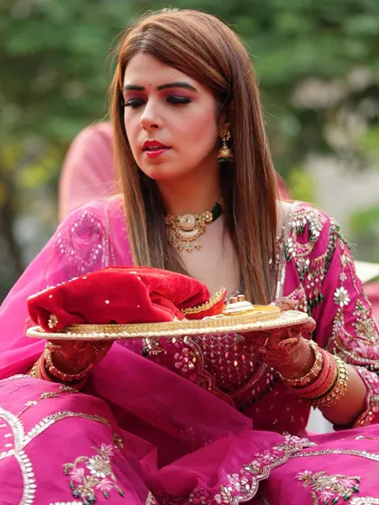 The client is holding her puja thali, and you can see the intricate mehendi I did for her, matching her beautiful traditional outfit.