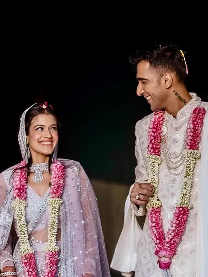 The color version of the previous portrait. The vibrant pinks of their garlands and her lehenga add a layer of celebration and beauty.