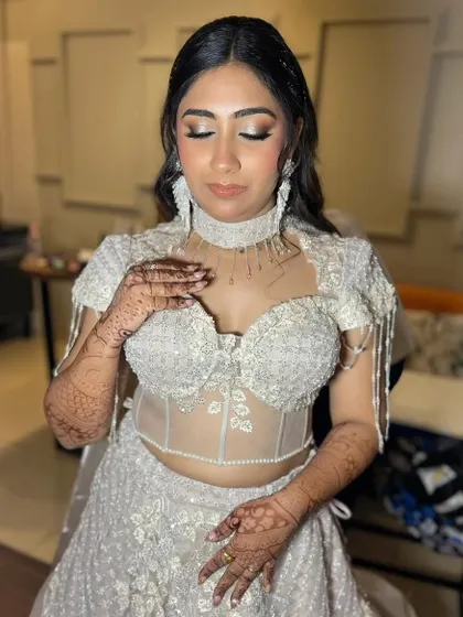 Even with eyes closed, the glamour shines through. This shot highlights the intricate eyeshadow blending and the shimmering details that make this look perfect for an evening event.