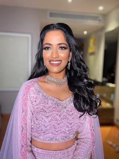 Deepanshi is ready for her sangeet in this goddess-like look. I used soft lavender and pink tones on her eyes to match her beautiful lehenga.