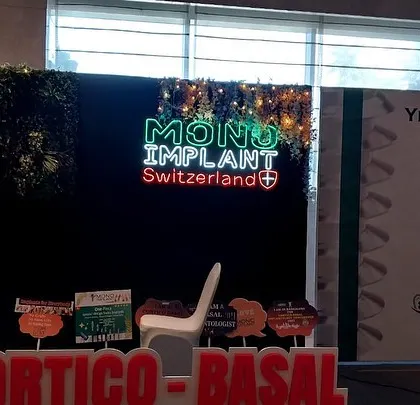A creative photo booth area within the Mono Implant exhibition, using a neon logo and a green wall. I incorporate interactive elements into booth designs to increase visitor engagement and social media visibility.