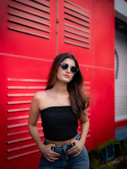 A duplicate of image 103, this shot captures a cool and effortless street style vibe against a bold red background.