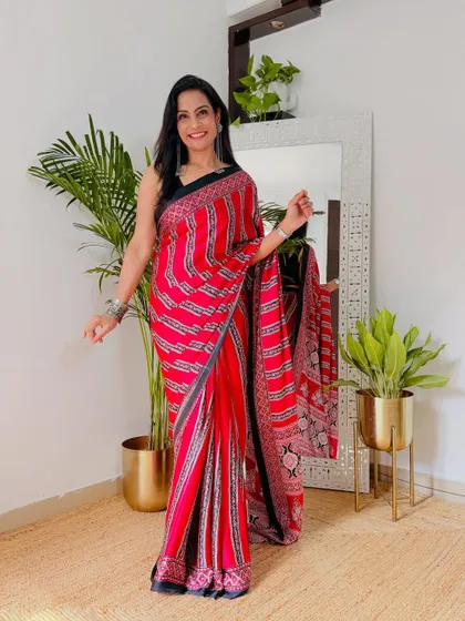 This red printed crepe saree has a very contemporary feel. It's perfect for those who want to wear a saree to work or a casual event but with a modern twist.