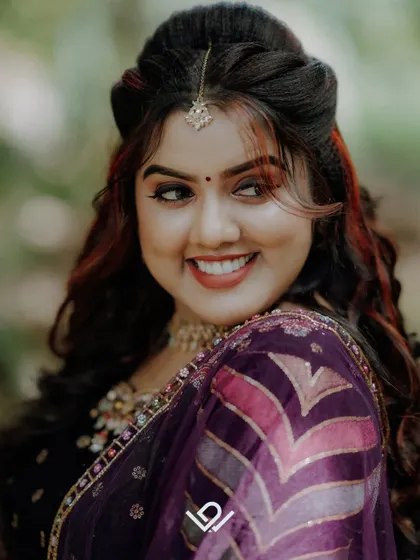A bright, happy close-up of a bride, her joyful smile and beautiful makeup taking center stage.