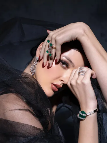 A dramatic, moody shot featuring emerald and diamond jewelry against a dark, veiled backdrop. This shows my ability to create a specific atmosphere that enhances the story of the collection.