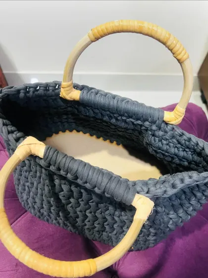 A top-down view of the T-shirt yarn bag, showing the sturdy wooden base that helps it keep its shape.