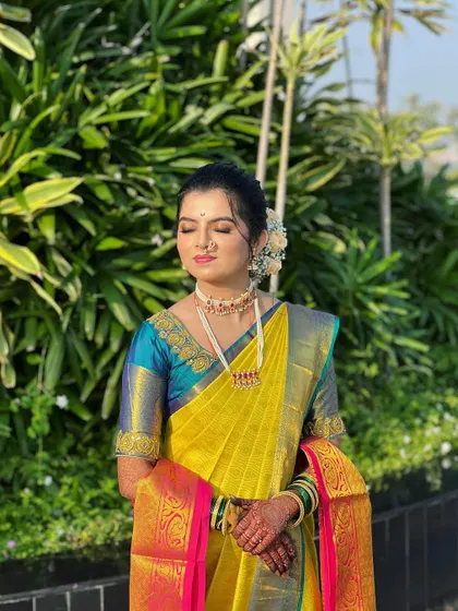 A serene moment with the bride in her yellow Nauvari. The drape is designed to be comfortable and elegant, allowing for beautiful, natural portraits.