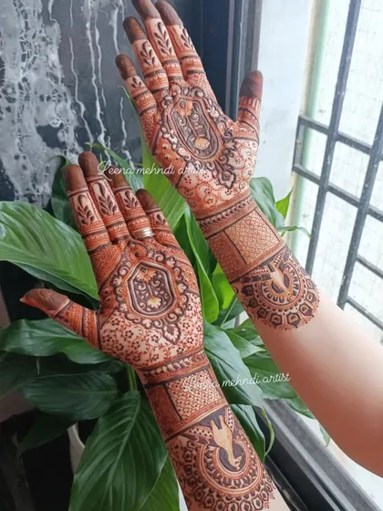 Simple yet elegant, this design is perfect for a bride's family or for someone who prefers a less dense pattern. It features traditional figures within a central mandala, complemented by detailed wrist bands.