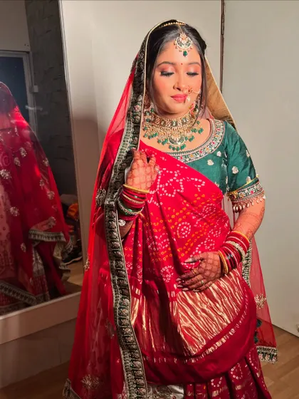 My beautiful Gujarati bride Gauri, her red bandhani dupatta adding a traditional touch to her green and red lehenga.