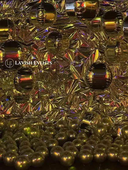 The same metallic photobooth under gold lighting, showing its versatility.