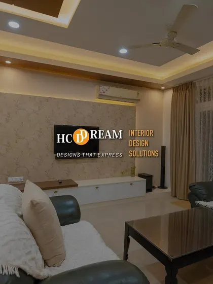 A comfortable and cozy living room setup, perfect for family movie nights. The design combines plush leather sofas with soft throws and warm ambient lighting.