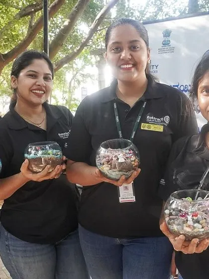 Four students from Ramaiah University proudly holding up the terrariums they created. Each one is a small, living world they can take back to their dorms.