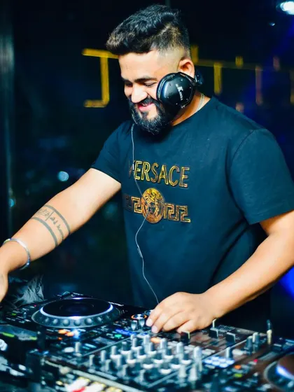 A happy, candid moment behind the decks. The joy of music is contagious.