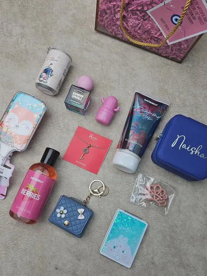 Here is an unboxed view of the sister's hamper, showing all the individual items including the personalized jewelry case, mini-wallet, stationery, and beauty products.