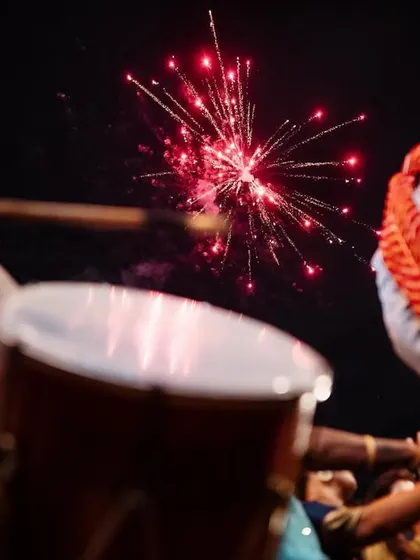 The groom's grand entrance on a decorated horse, with fireworks lighting up the night sky. We capture the spectacle and excitement of the baraat.