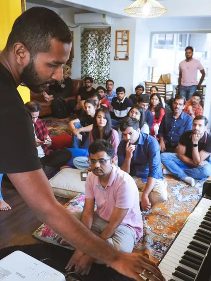 A teacher demonstrating a piano technique during a workshop. Our instructors provide personalized, hands-on guidance to help every participant learn effectively.