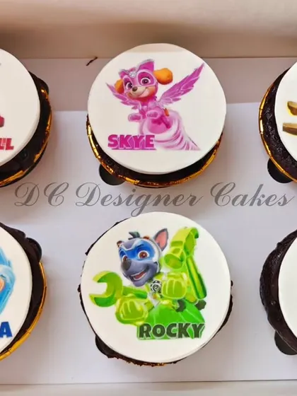 A set of Mighty Pups themed cupcakes for a Paw Patrol fan. Each cupcake features a different character like Marshall, Skye, and Chase, printed on an edible disc.