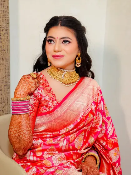 A close up of the bride, showing her soft makeup and the beautiful texture of her silk saree.