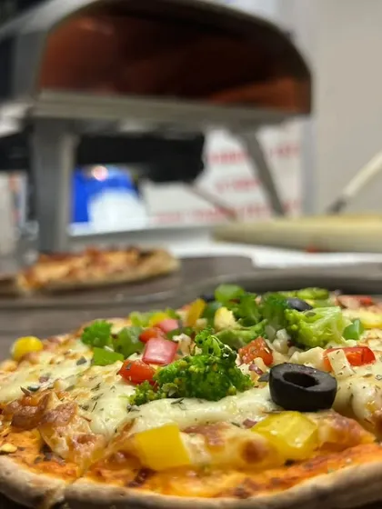 A freshly baked vegetable pizza, straight from our portable oven. Our live pizza station is a fantastic addition to casual corporate parties and outdoor events.