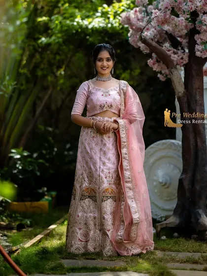 A full-length standing view of the pink lehenga, highlighting its graceful silhouette and intricate detailing.