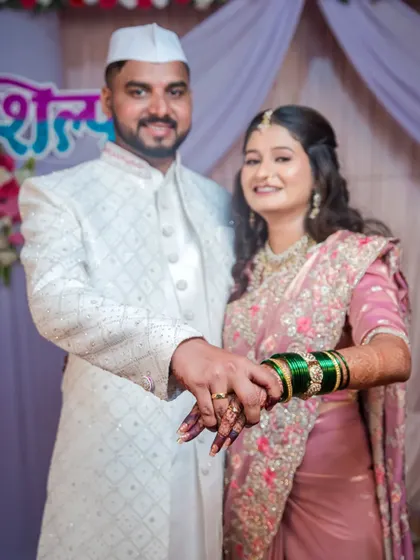 The couple shows off their rings together, symbolizing their new union. This is a classic and essential shot for any engagement album.