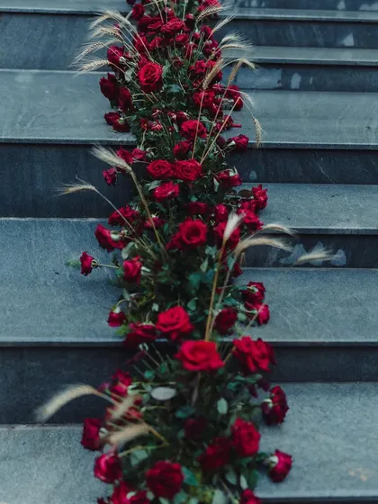 A close-up of the candle-lit pyramids that formed the backdrop for a traditional Bunt ceremony. These custom structures, combined with deep red floral arrangements, created a warm, glowing ambiance.