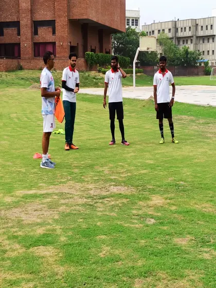 Our coaching staff listening intently during a development workshop. We are dedicated to improving our skills to better serve our young athletes.