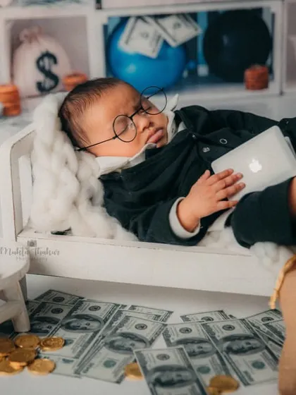This little boss baby is dreaming of his next big merger. The tiny laptop and money bags make this 3-month-old shoot so much fun.