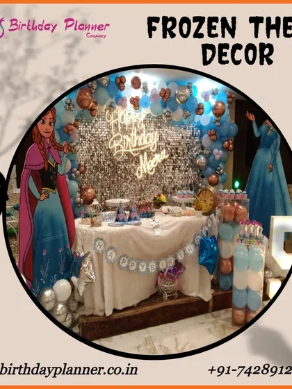 A magical Frozen theme party for Neera. This decor features a shimmering silver sequin backdrop, character standees of Anna and Elsa, and a balloon arrangement in icy blues and whites to create a winter wonderland.