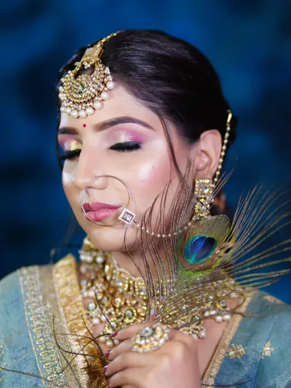 This bridal look incorporates a peacock feather, showing how creative elements can be woven into traditional makeup. Our courses encourage students to think outside the box.
