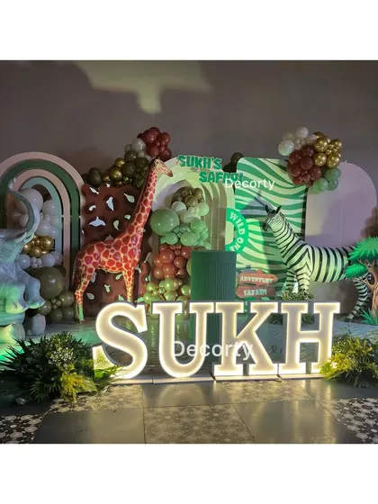 The main stage for Sukh's safari party, brightly lit and full of fun animal characters.