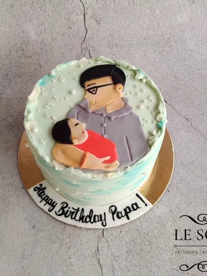 A special cake for a new dad's first birthday as a papa. This half-kg Chocolate Butterscotch cake features a heartwarming 2D fondant portrait of the father and his new baby.