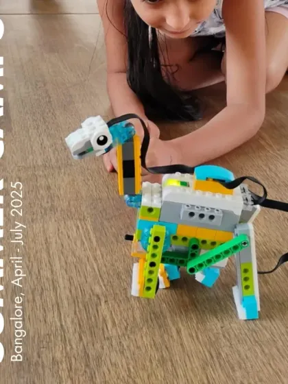 A student plays with her robotic dinosaur, a project she built and coded during our Summer Camp in Bangalore.