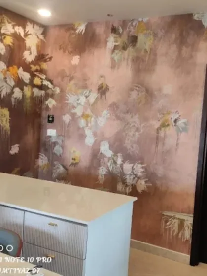 An abstract floral wallpaper in warm, earthy tones, adding a touch of modern art and texture to this kitchen counter area.