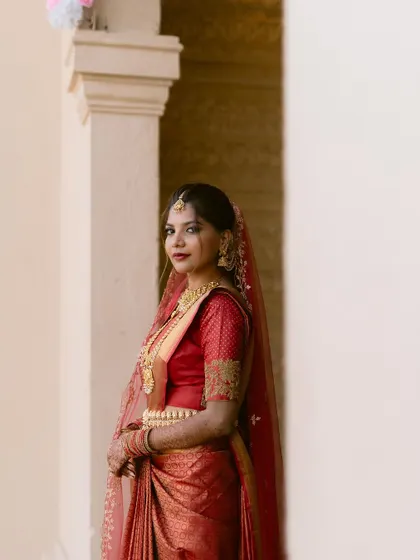 A beautiful portrait of a bride in a striking red saree. We use simple, elegant backgrounds to ensure the focus remains entirely on her.