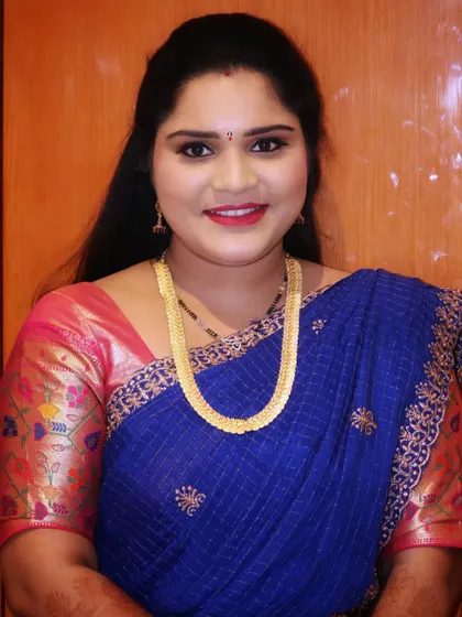 A beautiful smile from the bride's sister. Her makeup is fresh and radiant, making her look perfect for celebrating with her family.