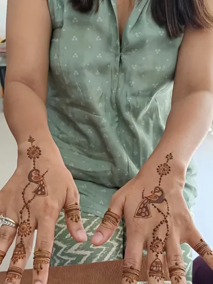 A simple yet charming design featuring a bird and a jhumka (earring) motif. This is a creative and light pattern for any celebration.