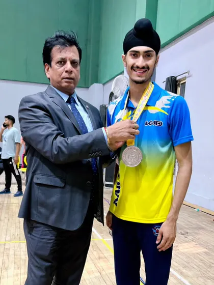 Receiving my silver medal from an official at the All India Karate Championship. A moment of recognition for the hard work.