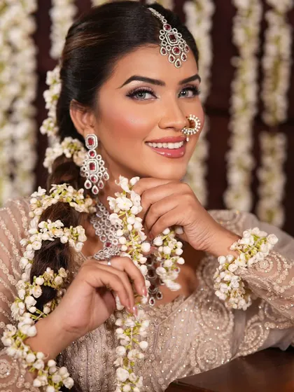 A beautiful traditional look with a modern touch. The makeup is classic and clean, while the floral jewelry adds a unique and fresh element.