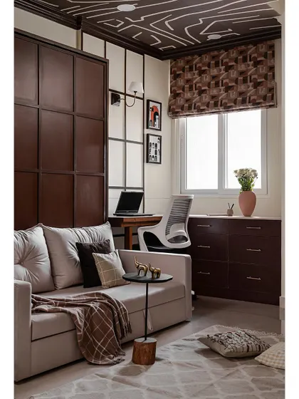 This versatile studio room features a Murphy bed that transforms into a sleek wall panel when closed. The beading details on the panel echo the design of the study nook, creating a cohesive look.