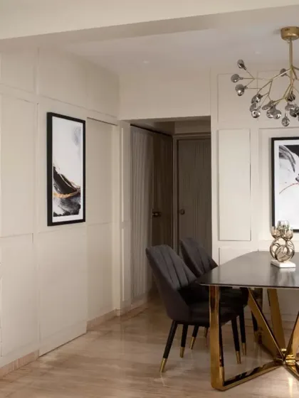 Another angle of the dining area, showing the relationship between the table, the hidden bar paneling, and the passage beyond. The consistent use of paneling creates a sense of rhythm and flow.