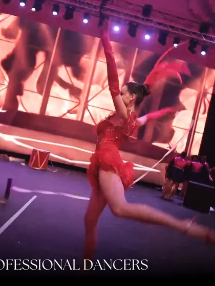 Our professional dancers add a layer of polish and spectacle to any sangeet. Here, a dancer in a vibrant red costume performs a high-energy routine, showcasing the skill and artistry our team brings to every event.