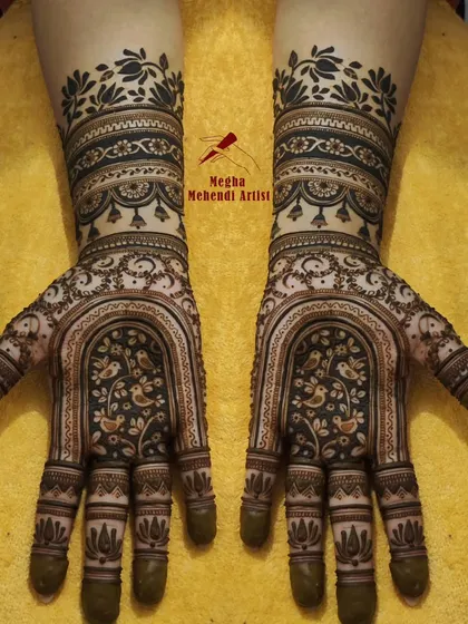 This unique design features a beautiful archway on the palms filled with delicate birds, creating a picturesque scene. The wrists are adorned with contrasting dark and light bands for a striking effect.