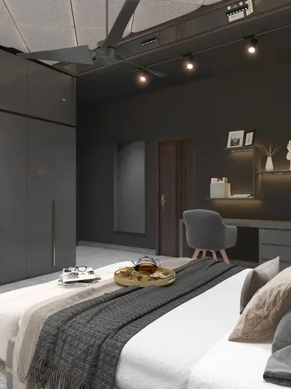 A modern bedroom with a moody, dark grey theme, featuring sleek, high-gloss wardrobes and a dedicated study nook.