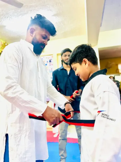 Another student achieves the rank of black belt.
