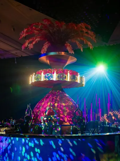 A whimsical, colorful centerpiece with a carousel motif, showcasing our ability to create playful and imaginative designs.