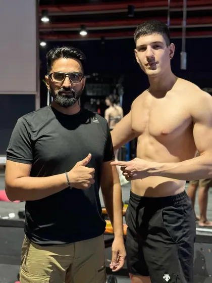 A proud moment with a client who has achieved incredible results through his strength training program. Celebrating these victories together is a huge part of what we do.