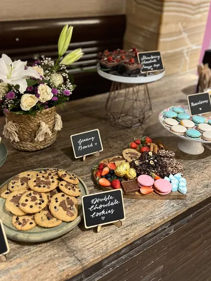 A full dessert table I set up for a party, featuring a variety of my eggless treats like cookies, macarons, mousse cups, and a grazing board.